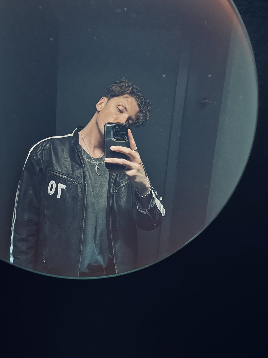 Couché, mirror portrait in a leather jacket